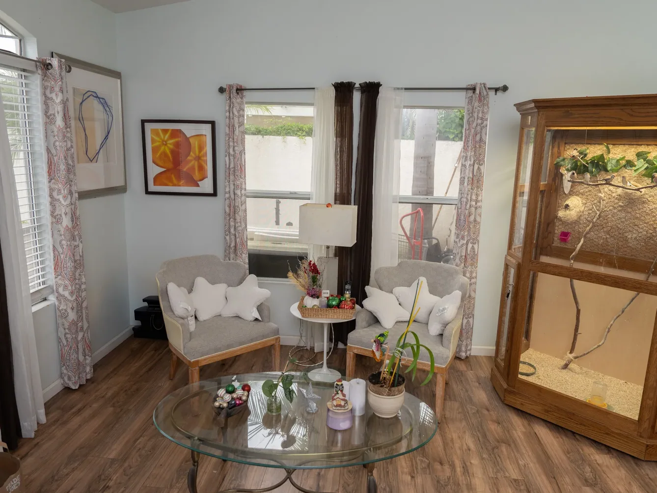 Comfortable living room with armchairs and decorative artwork.